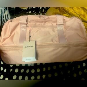 Calpak Stevyn Rolling Duffel Bag in Blush Pink